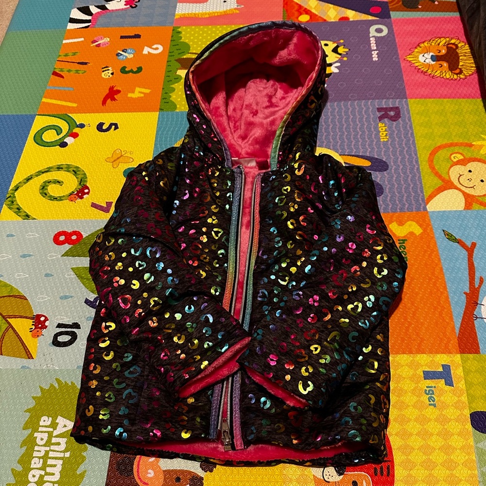 Colorful black jacket with metallic accents.